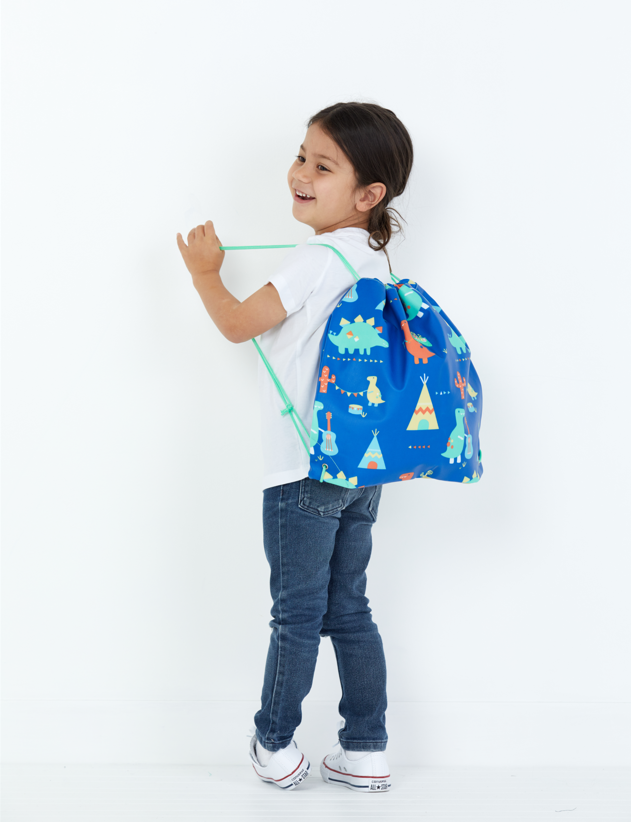 Girl in a white shirt and jeans wearing a Penny Scallan Drawstring Bag Dino Rock